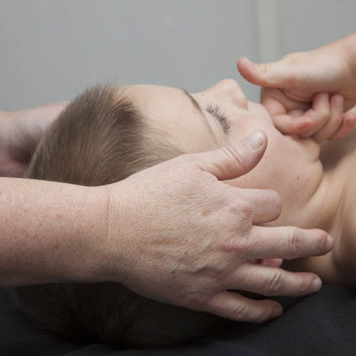 young child getting bowenwork treatment